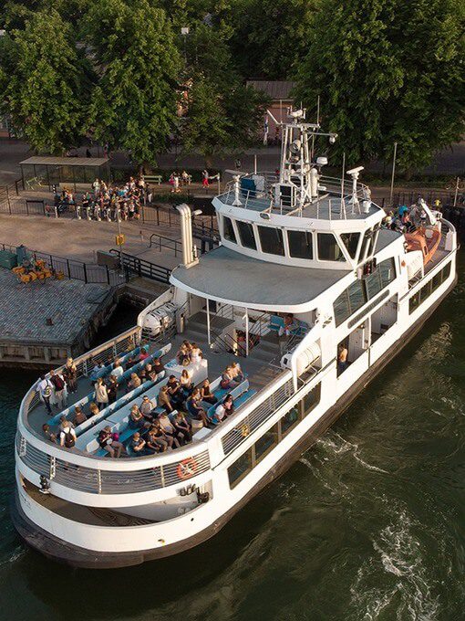 Passengers on a white HSL ferry crossing the Baltic Sea from Kauppatori to Suomenlinna, a popular and budget-friendly activity for urban explorers.